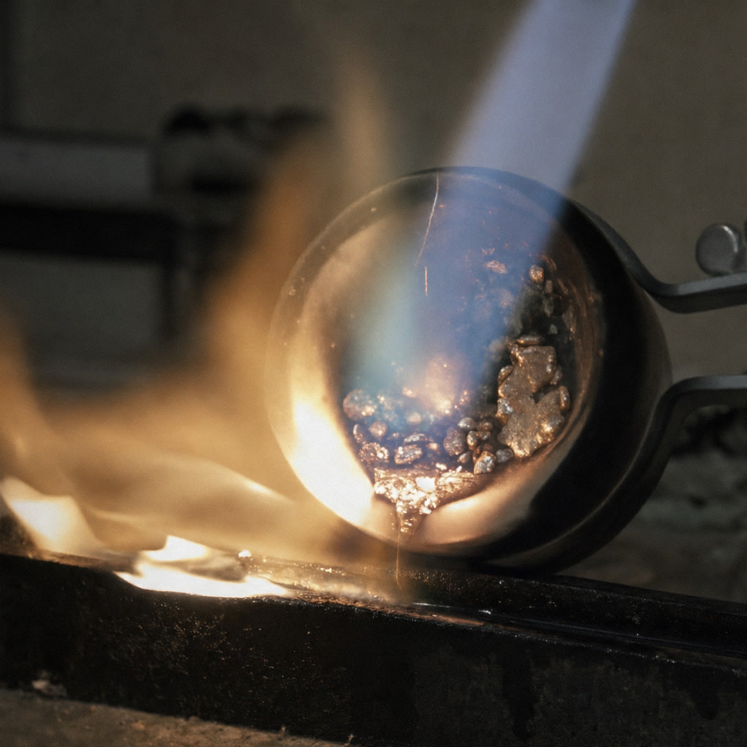 Molten gold poured from a crucible as part of the custom jewelry design and casting process.