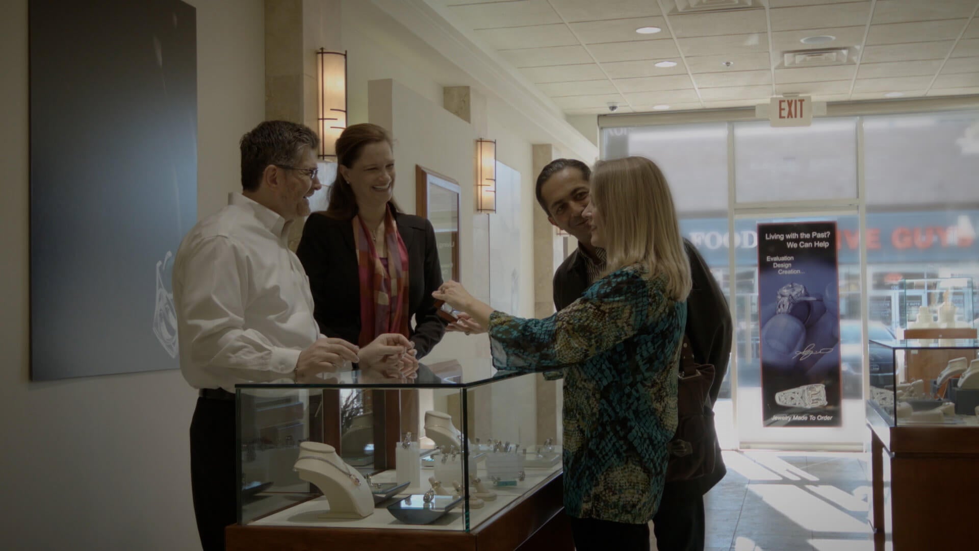 A photo of two customers excited to receive an amazing ring from inside the store of Demirjian Design.