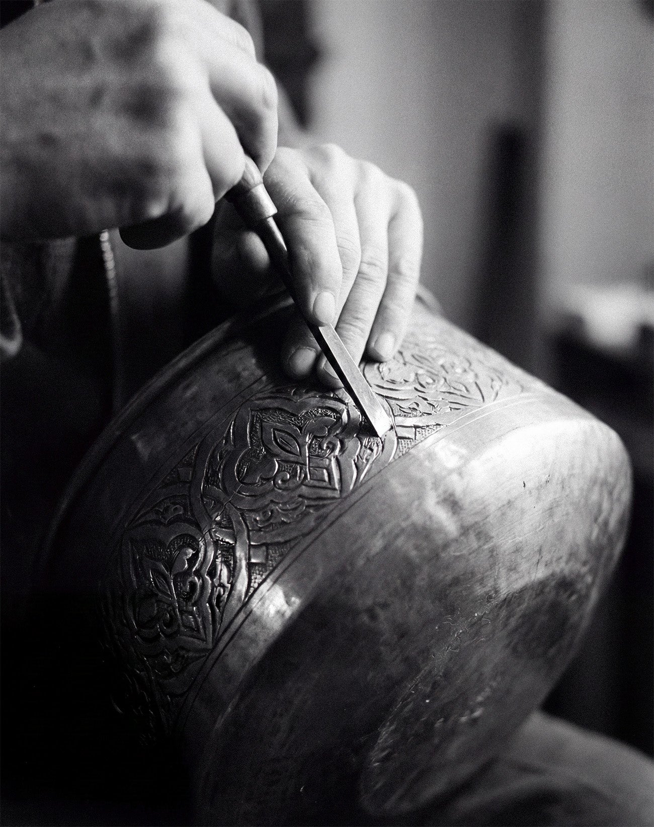 Historical photo of a Demirjian artisan performing detailed metal engraving.