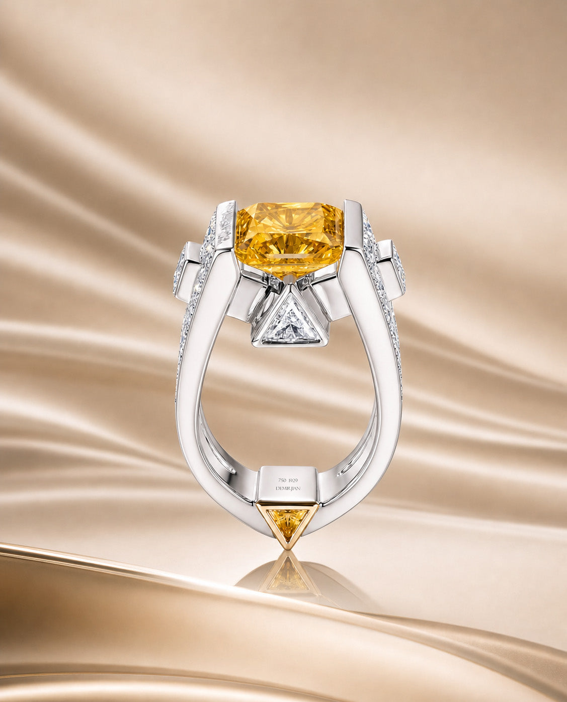 Elegant Demirjian Works of Art ring with a fancy vivid yellow diamond on a beige gold background.
