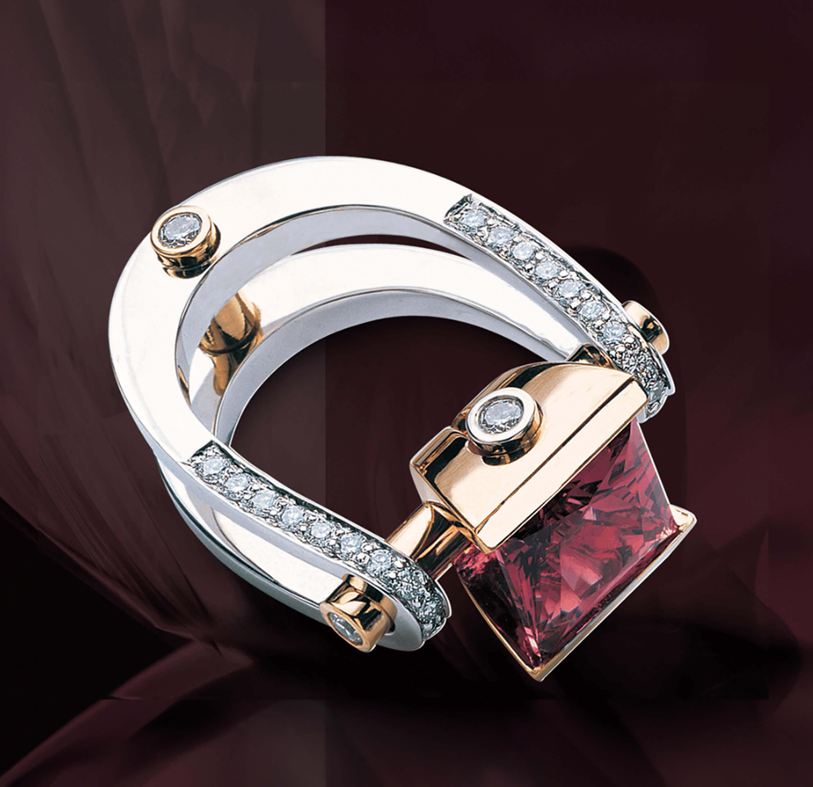 Two-tone Garo Demirjian ring with a square red gemstone and diamond accents.