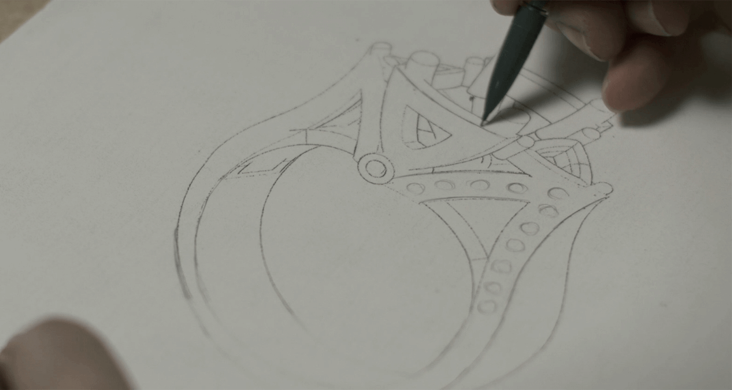 Garo Demirjian sketching a ring on a piece of paper.