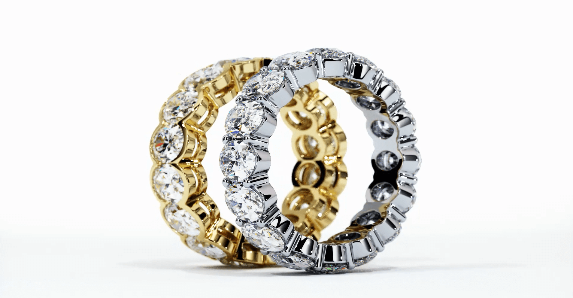 A side profile of custom diamond wedding rings, one made from 24K gold and 14K white gold, each set with multiple diamonds, showcasing the luxurious and custom design elements of high-end jewelry.