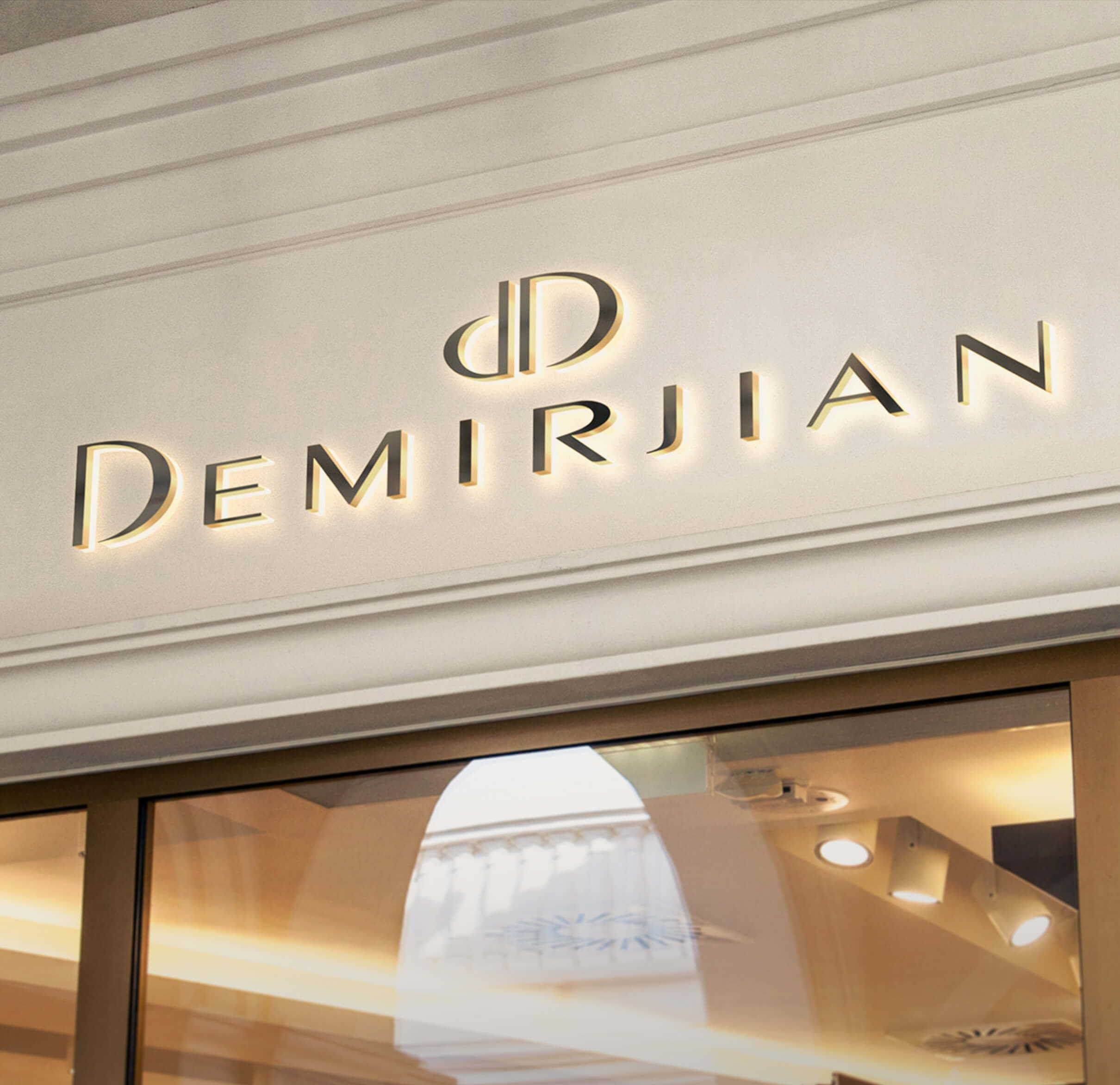 Demirjian logo on a building facade with illuminated text.