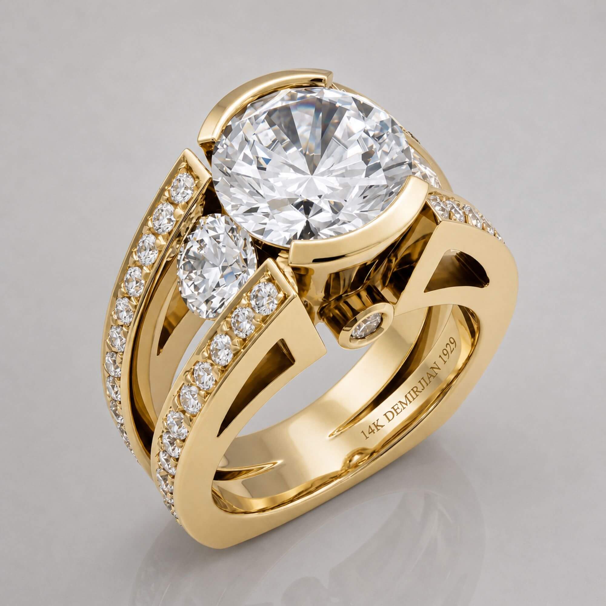 Custom round brilliant diamond engagement ring in 14K yellow gold with open split shank, handcrafted at Demirjian atelier since 1929.