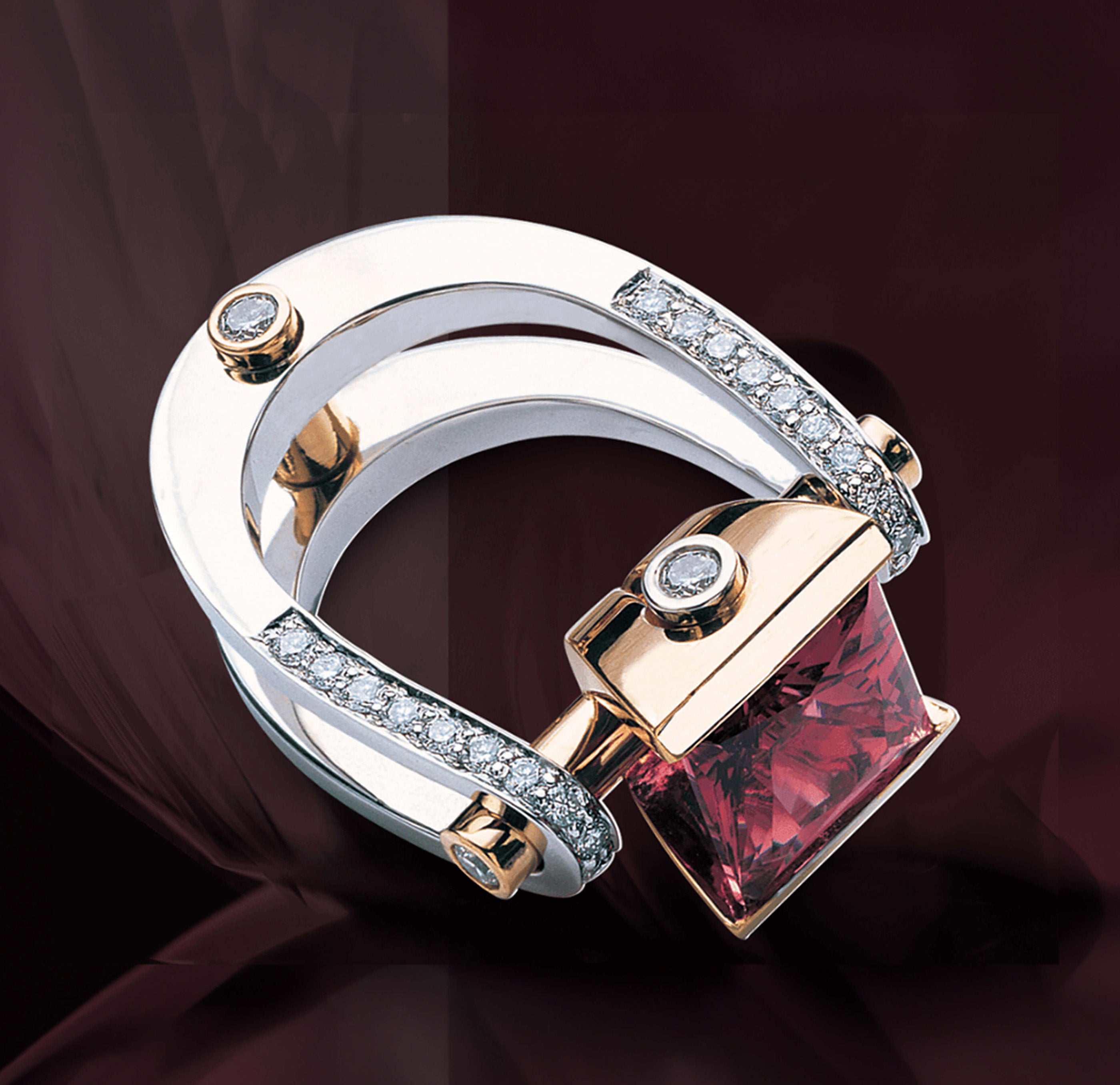 Two-tone Garo Demirjian ring with a square red gemstone and diamond accents.