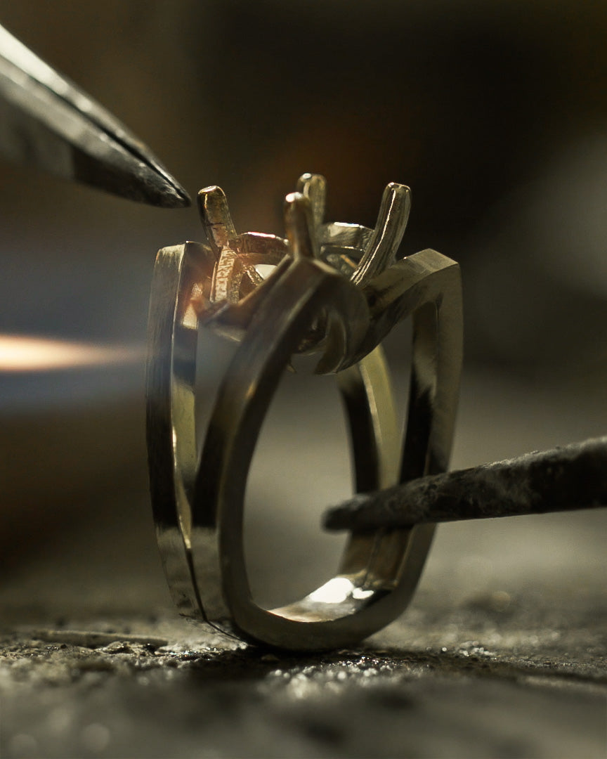 Detailed view of the heating and soldering phase of a custom ring creation by Demirjian Works of Art.