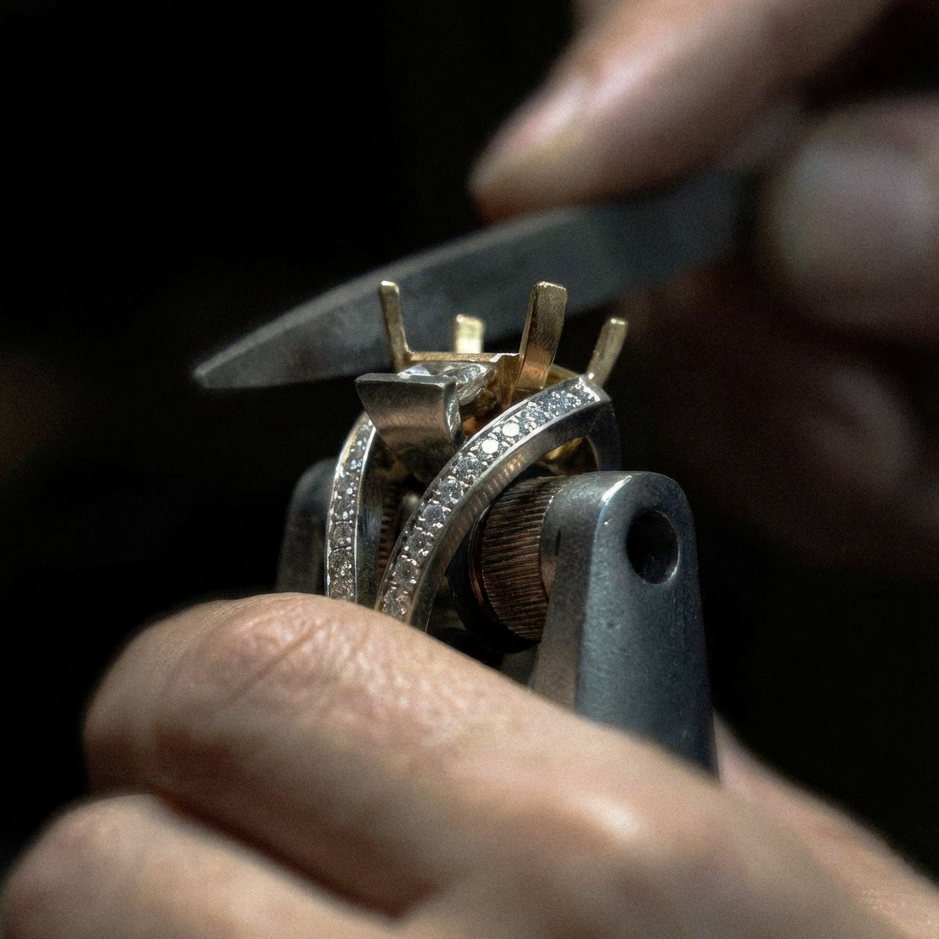 Artisan craftsmanship behind a Demirjian Works of Art jewelry piece, showing the detailed filing of a diamond ring setting.
