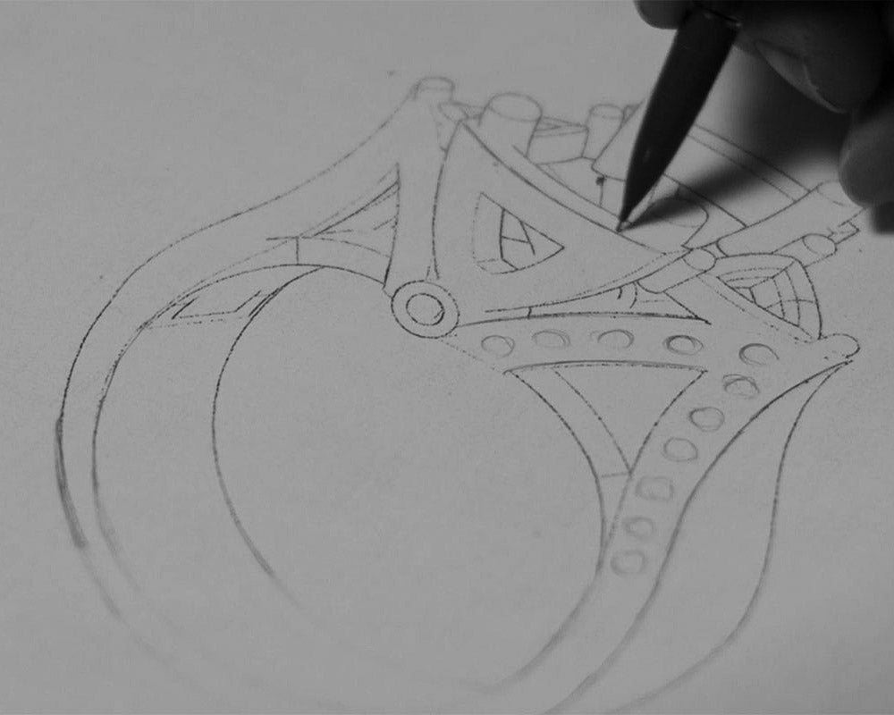 A concept sketch of a ring being drawn, representing the initial consultation step where materials and styles are outlined for a custom piece.