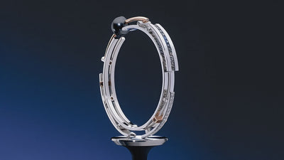 A rotating view of a custom Garo Demirjian bracelet. The award-winning design from the early 2000s pushes the boundaries of innovation with a unique hinged structure, white and rose gold metals, and a black pearl centerpiece.