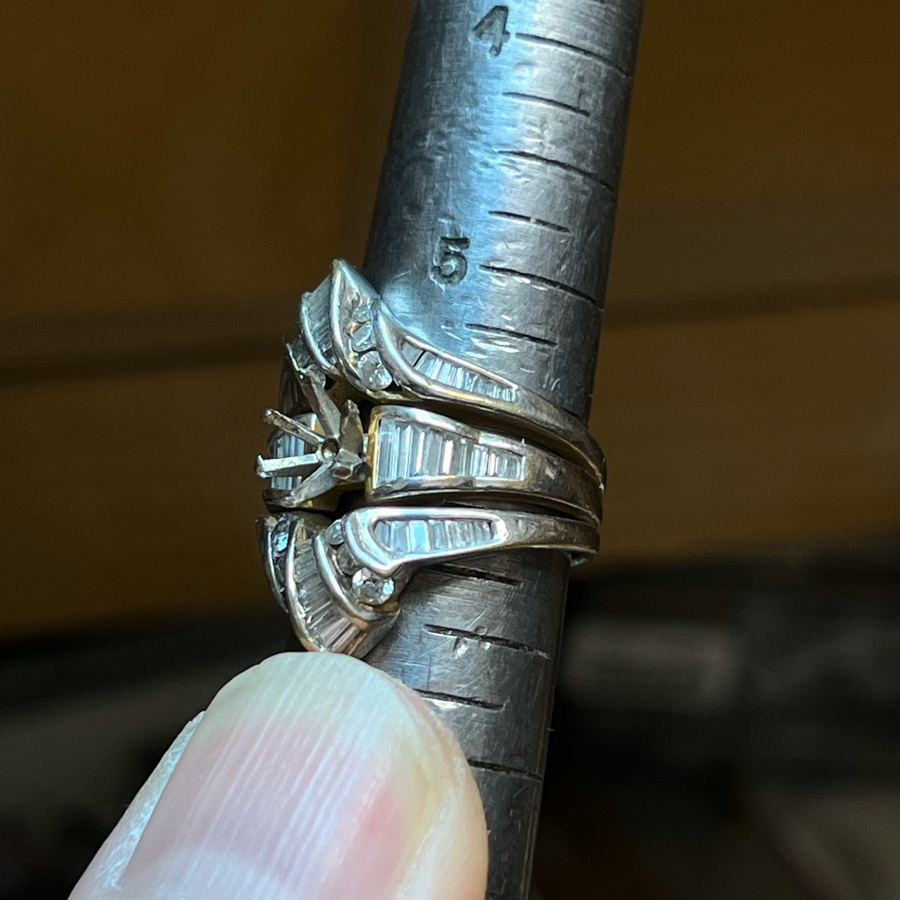 A close up of a ring being sized as a service.