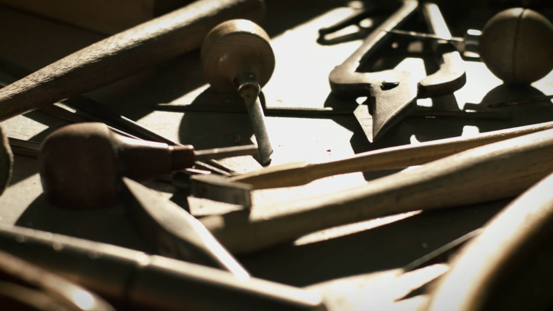 Image of a variety of tools on a work bench used for jewelry repair.